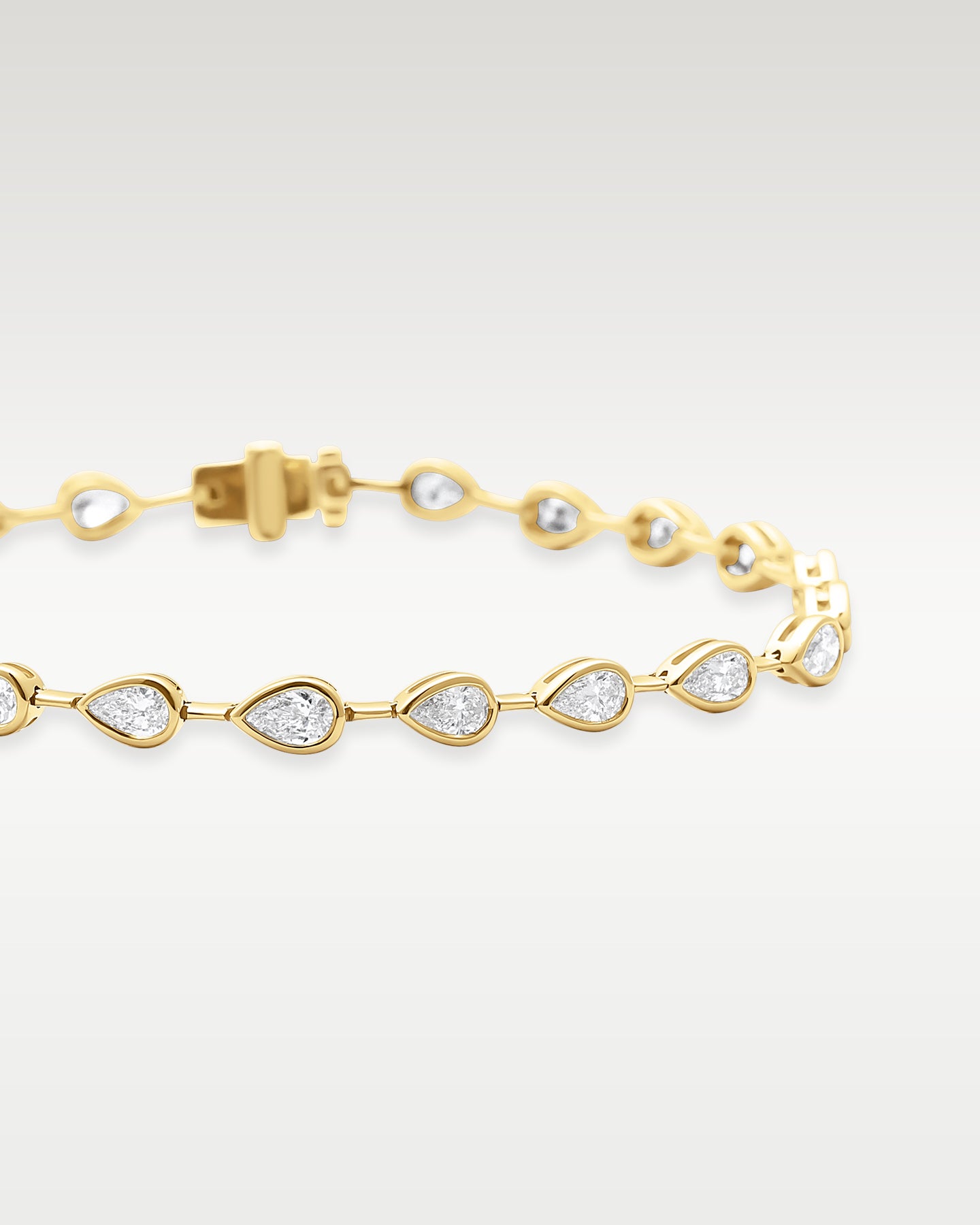 Yellow Gold Bezel Set Pear Diamond Tennis Bracelet | Noah's Fine Watches & Jewelry DFW