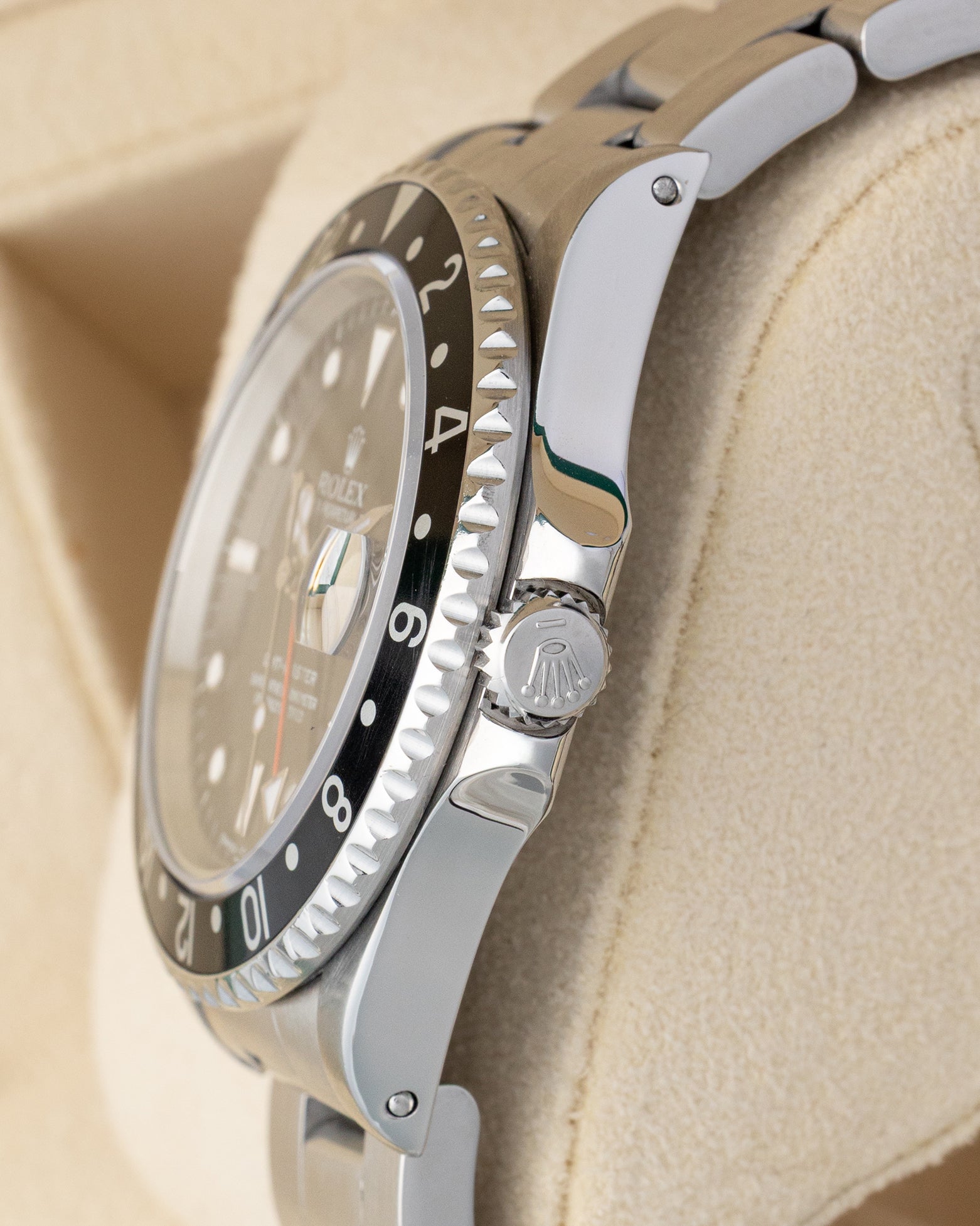 Side profile detail showing the 40mm stainless steel case with lug holes, crown guards, and signed Twinlock winding crown on a 1993 Rolex GMT-Master 16700