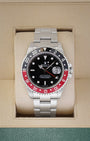 2000 Rolex GMT-Master II 16710 luxury watch with a black and red Coke bezel insert inside a Rolex presentation box