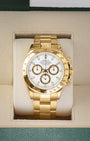 2002 solid 18k yellow gold Rolex Daytona 116528 featuring a white dial with gold-rimmed sub-dials, presented inside its official box