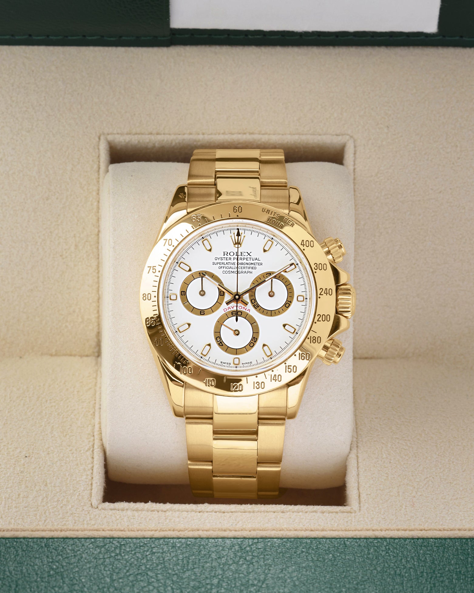 2002 solid 18k yellow gold Rolex Daytona 116528 featuring a white dial with gold-rimmed sub-dials, presented inside its official box