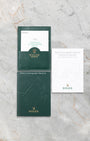 The official green Rolex portfolio folder containing the original chronometer guarantee paperwork and Daytona instruction manuals
