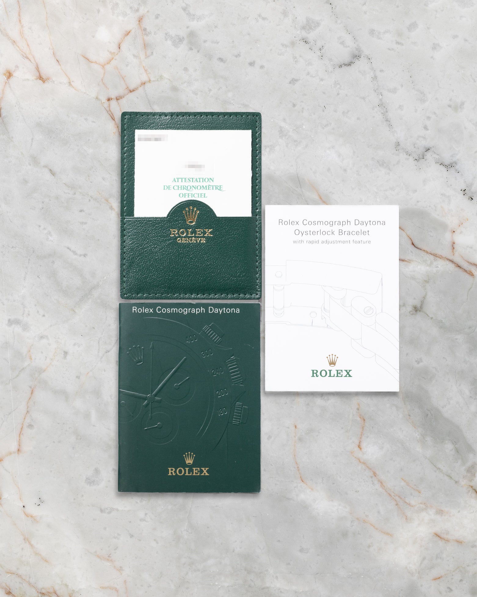 The official green Rolex portfolio folder containing the original chronometer guarantee paperwork and Daytona instruction manuals