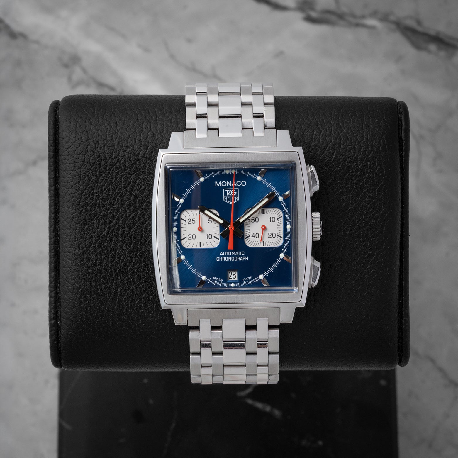 Pre owned 2005 TAG Heuer Monaco Automatic Chronograph CW2113.BA0780 with blue dial, square case, and stainless steel bracelet at Noahs Fine Watches and Jewelry in Dallas TX