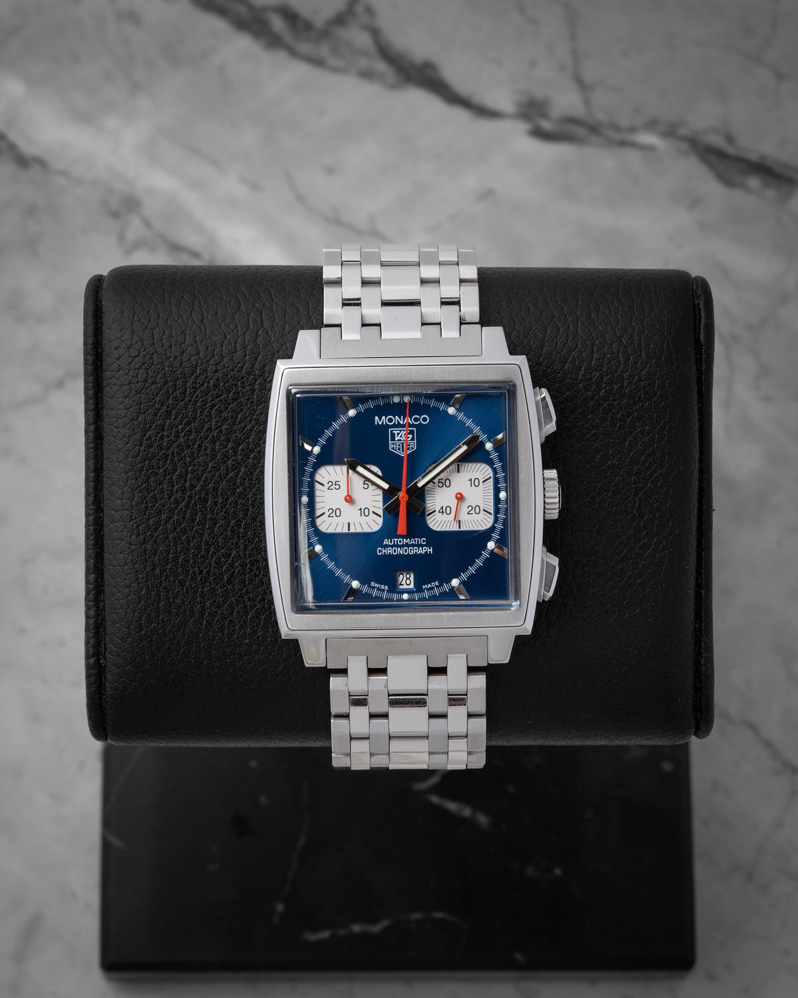 Pre owned 2005 TAG Heuer Monaco Automatic Chronograph CW2113.BA0780 with blue dial, square case, and stainless steel bracelet at Noahs Fine Watches and Jewelry in Dallas TX