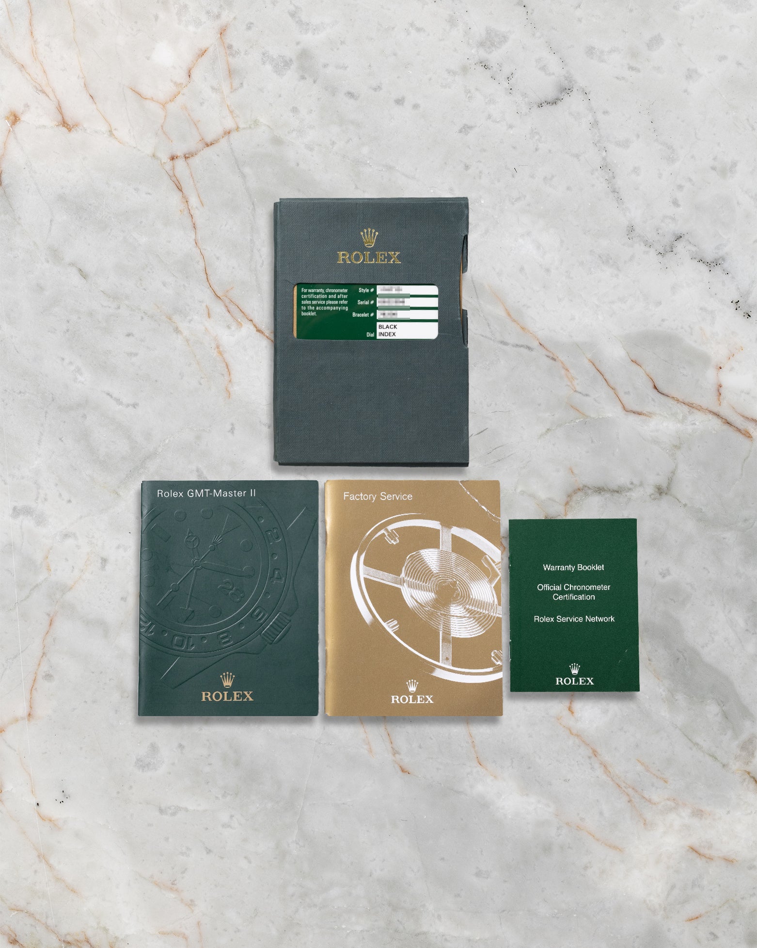 Complete documentation including official Rolex international guarantee card, green leather holder, GMT-Master II user manual, and factory booklets for reference 116710LN