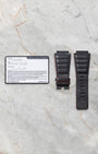 Official Bell and Ross international guarantee warranty card resting beside an unmounted replacement black leather racing strap