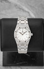studio front portrait of the 33mm Audemars Piguet Royal Oak 67651ST watch with a diamond bezel and silver Grande Tapisserie dial on a leather block