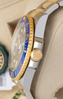 Side profile detail showing the 40mm stainless steel case, crown guards, and 18k yellow gold Triplock winding crown on a Rolex Submariner Date 116613LB