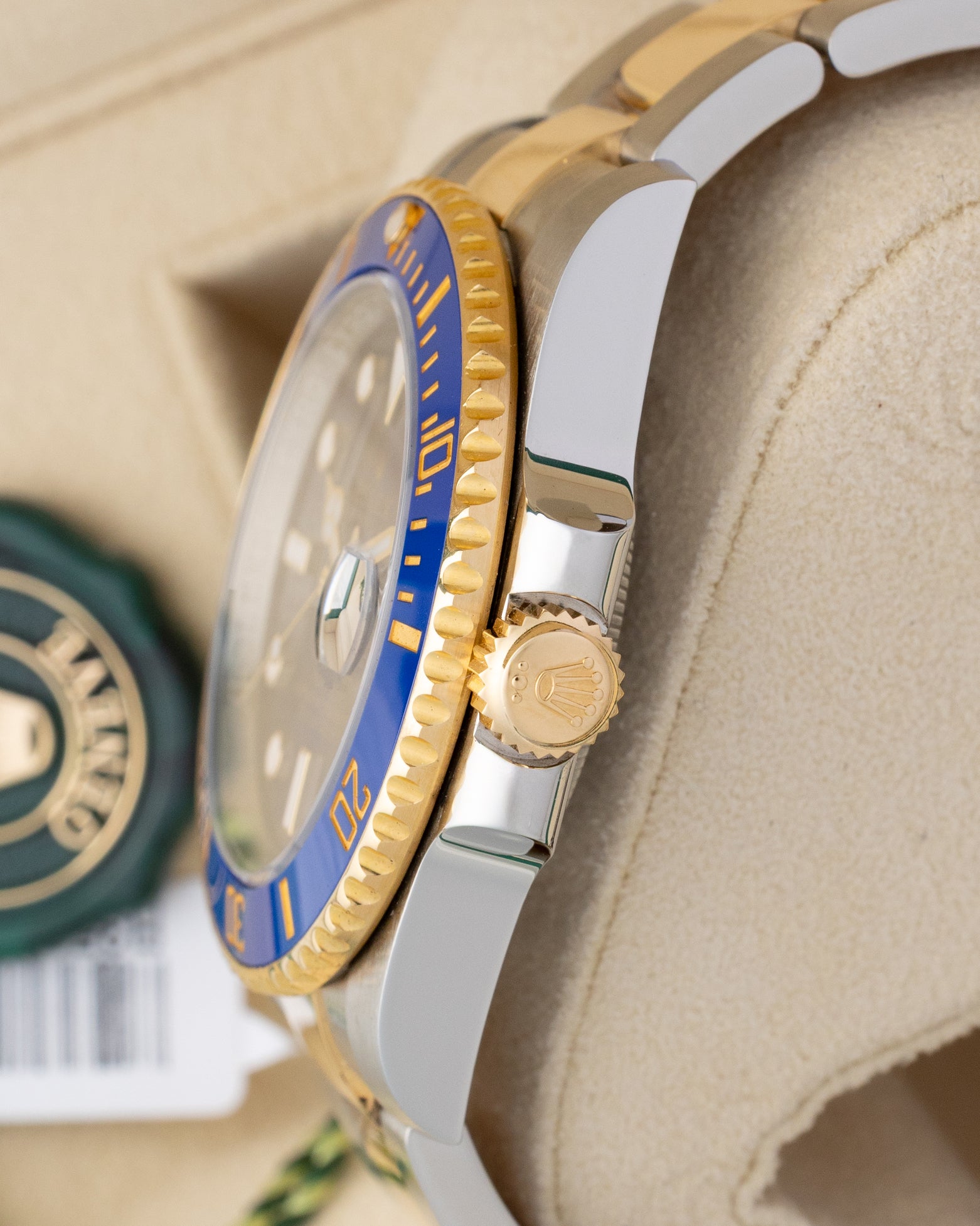 Side profile detail showing the 40mm stainless steel case, crown guards, and 18k yellow gold Triplock winding crown on a Rolex Submariner Date 116613LB
