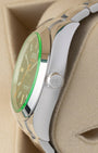 Side profile detail showing the 40mm stainless steel antimagnetic case, signed Twinlock winding crown, and green sapphire edge on a Rolex Milgauss 116400GV