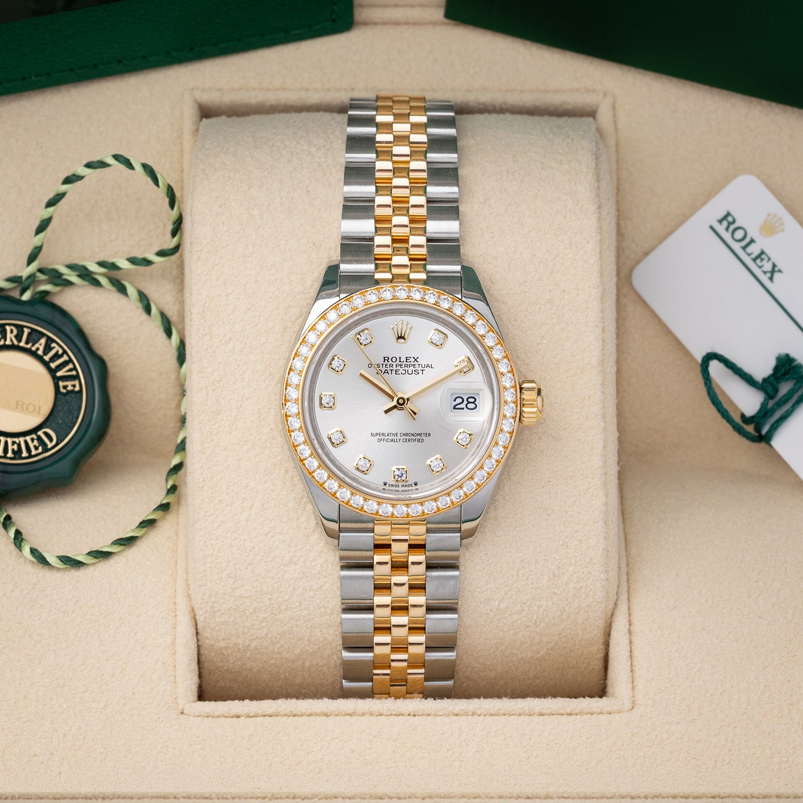 Preowned 2022 Rolex Lady-Datejust 28mm reference 279383RBR two-tone yellow gold and stainless steel watch with factory diamond bezel and silver diamond dial at Noahs Fine Watches and Jewelry in Dallas TX