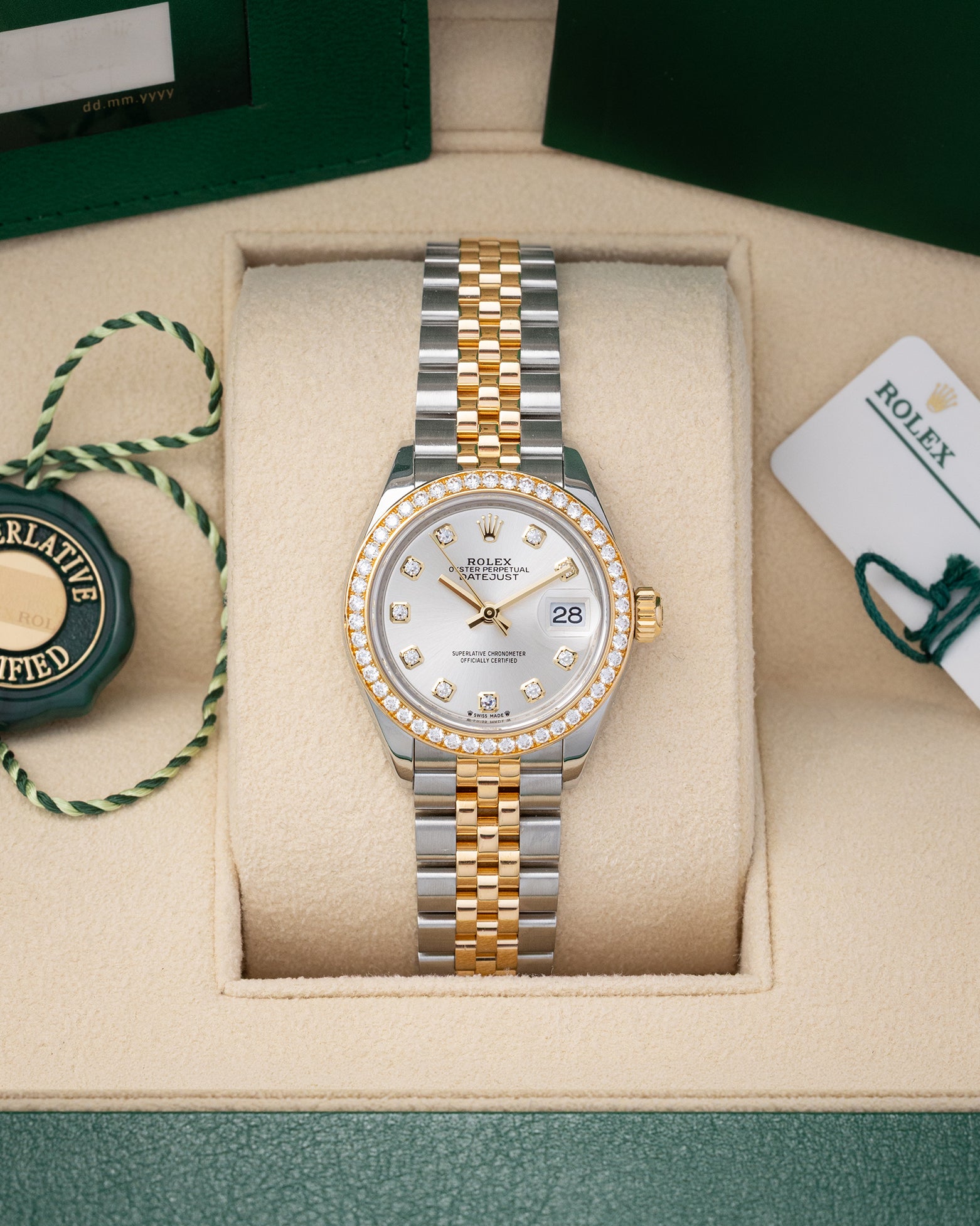 Preowned 2022 Rolex Lady-Datejust 28mm reference 279383RBR two-tone yellow gold and stainless steel watch with factory diamond bezel and silver diamond dial at Noahs Fine Watches and Jewelry in Dallas TX