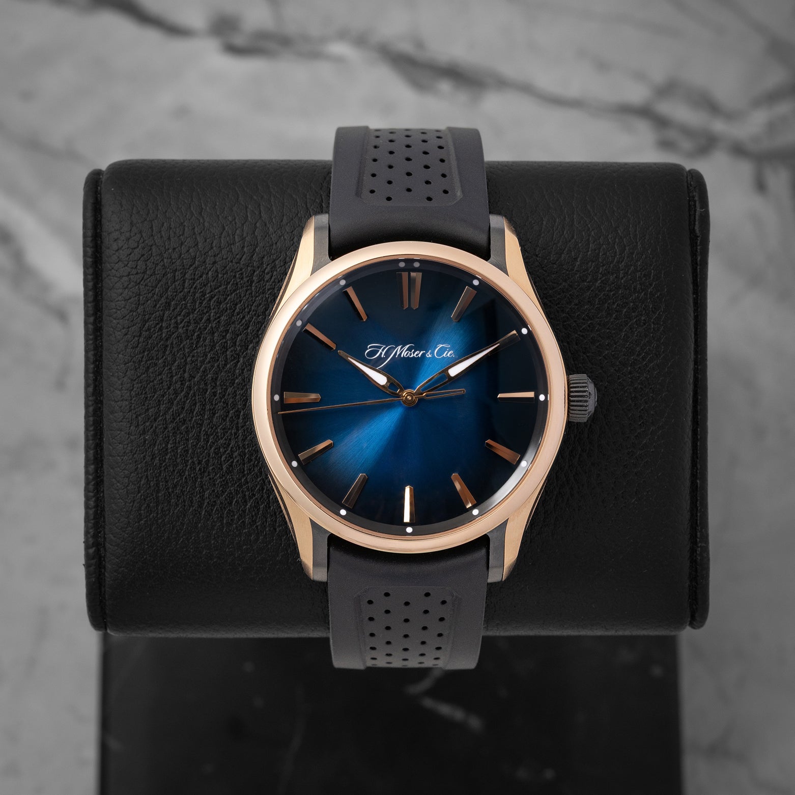 H. Moser & Cie. Pioneer Centre Seconds 3200-0903 sports watch with a Midnight Blue fumé dial and black rubber strap on a leather display mount