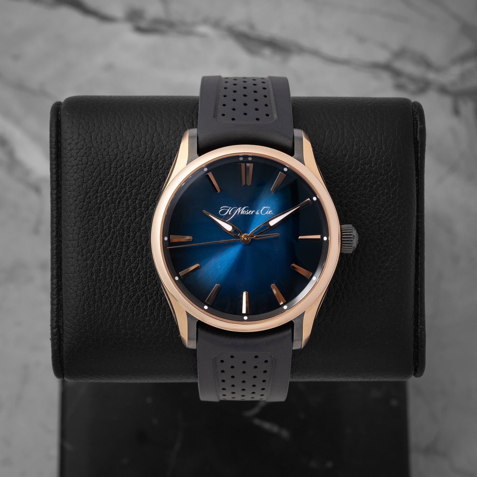 H. Moser & Cie. Pioneer Centre Seconds 3200-0903 sports watch with a Midnight Blue fumé dial and black rubber strap on a leather display mount