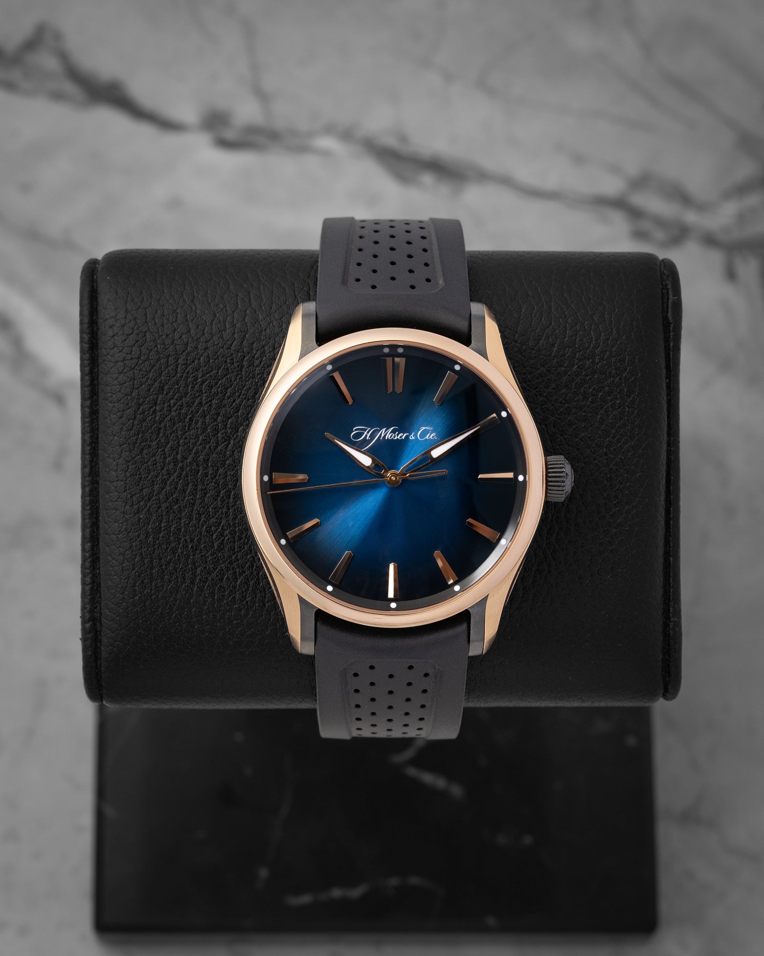 H. Moser & Cie. Pioneer Centre Seconds 3200-0903 sports watch with a Midnight Blue fumé dial and black rubber strap on a leather display mount