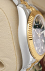 Left side perspective showcasing the distinct reflection on the 18k yellow gold fluted Ring Command bezel and curved steel lugs of the reference 336933