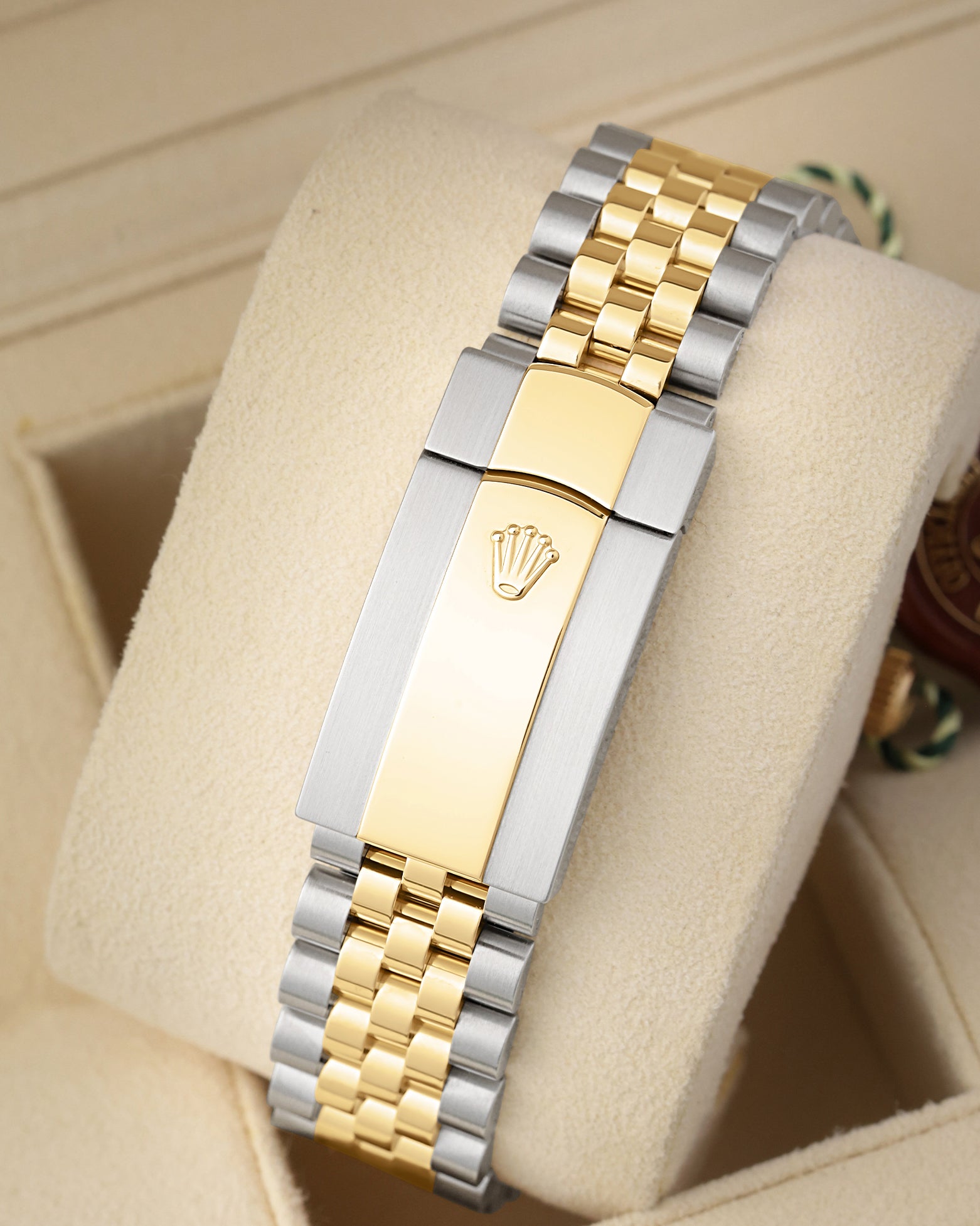 Rear perspective of the five-piece link Yellow Rolesor Jubilee bracelet and folding Oysterclasp featuring the embossed Rolex crown logo