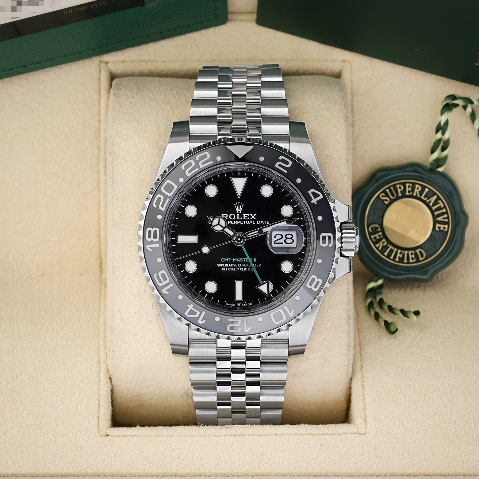 Preowned 2025 Rolex GMT-Master II 126710GRNR Oystersteel watch with grey and black ceramic bezel and green GMT hand on a Jubilee bracelet at Noah's Fine Watches and Jewelry Dallas Texas