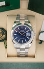 front portrait of a 2024 Rolex Datejust 41 126300 watch with a blue sunray dial and Oyster bracelet resting inside its luxury green presentation box