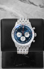 2026 Breitling Navitimer B01 Chronograph 46 AB0137 featuring a blue dial with white sub-dials on a black display stand