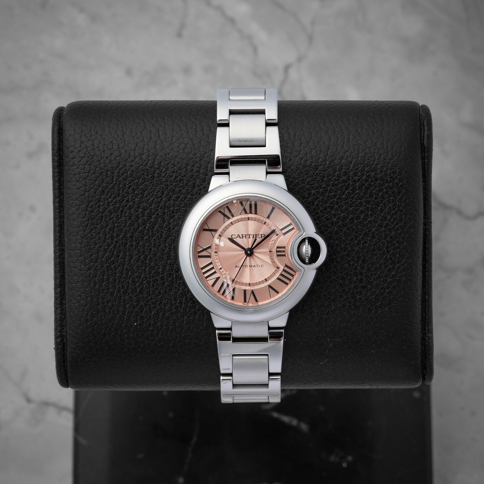 Cartier Ballon Bleu de Cartier watch with a pink guilloche dial Roman numerals and a stainless steel bracelet