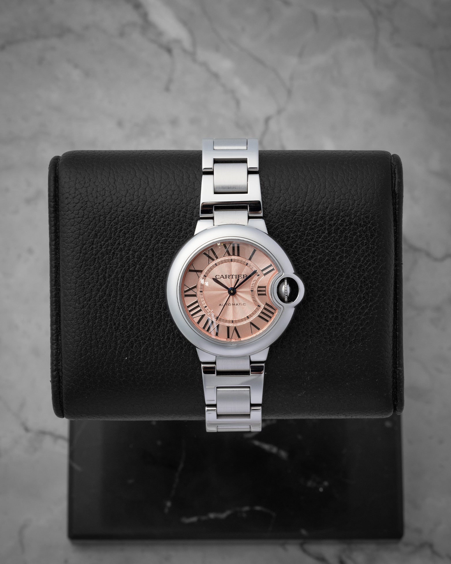 Cartier Ballon Bleu de Cartier watch with a pink guilloche dial Roman numerals and a stainless steel bracelet