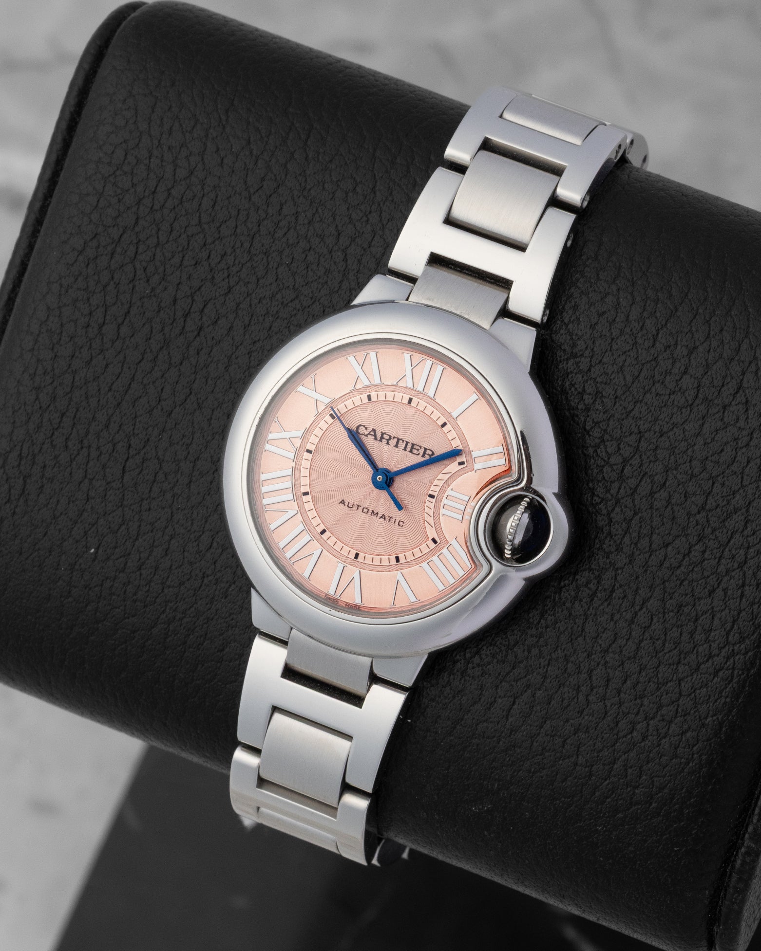 Cartier Ballon Bleu de Cartier watch with a pink guilloche dial Roman numerals and a stainless steel bracelet