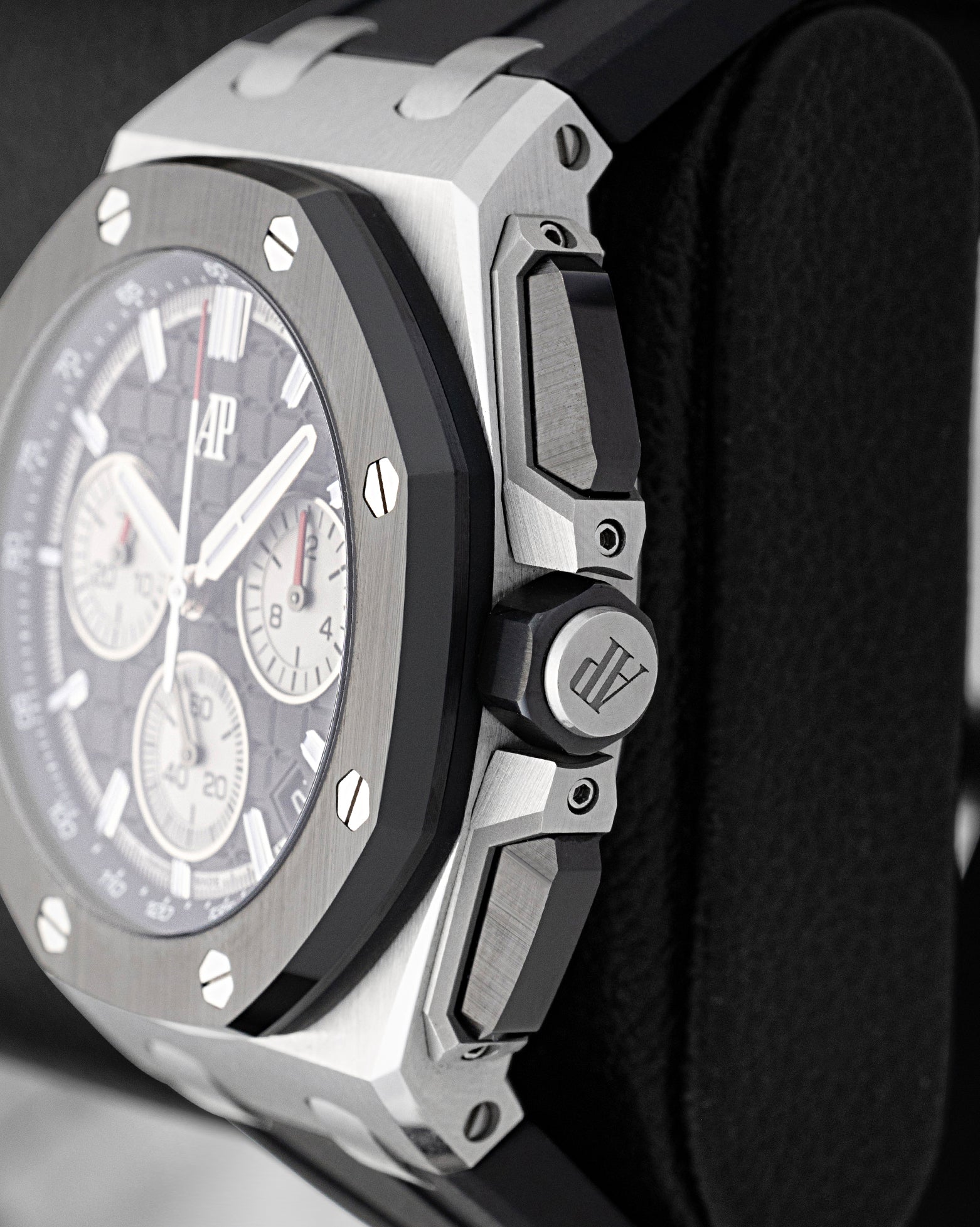 Side profile of AP Royal Oak Offshore 26420SO showing black ceramic screw-locked crown and push-pieces with titanium guards