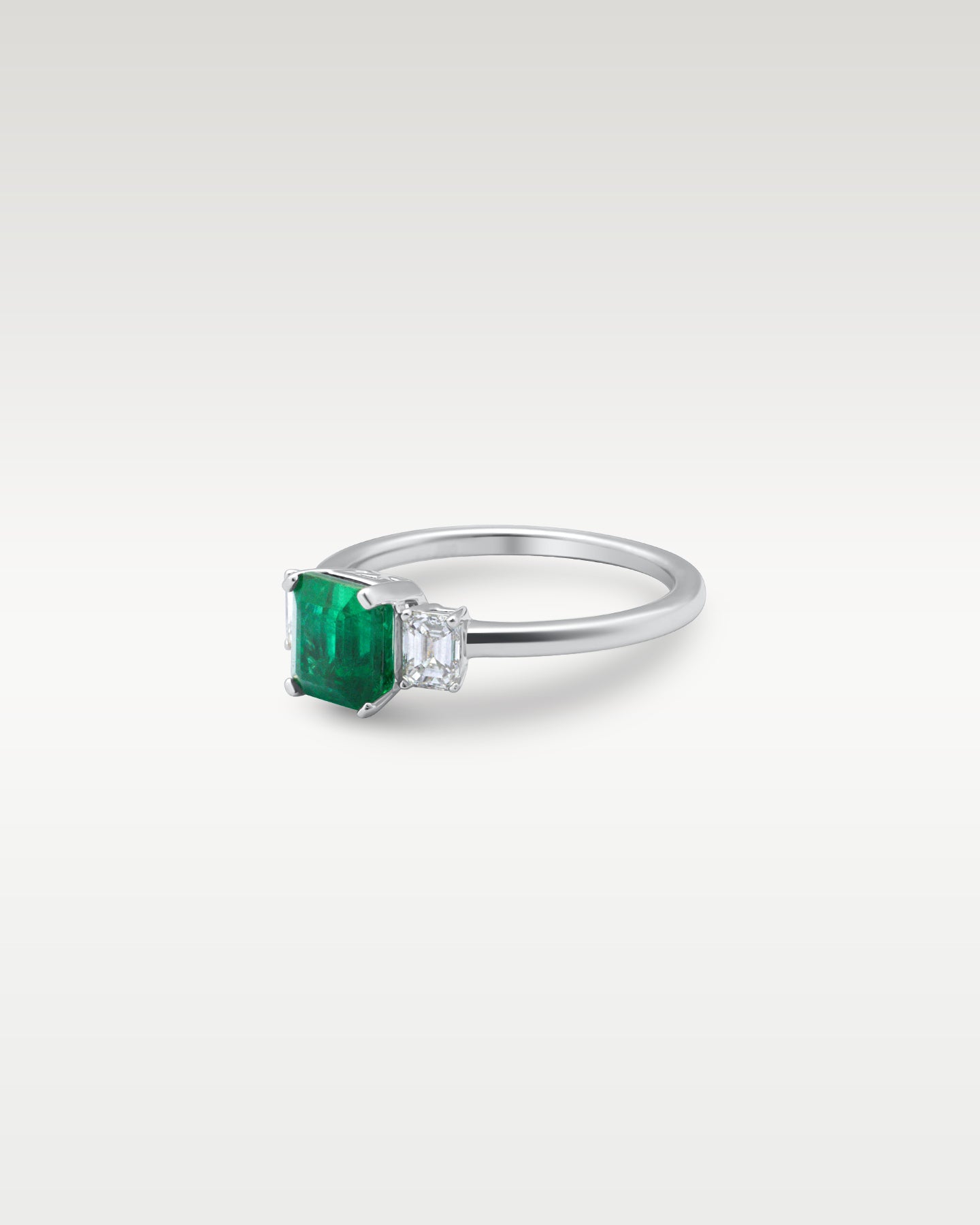 Platinum Three Stone Emerald and Diamond Ring | Noah's Fine Jewelry Dallas