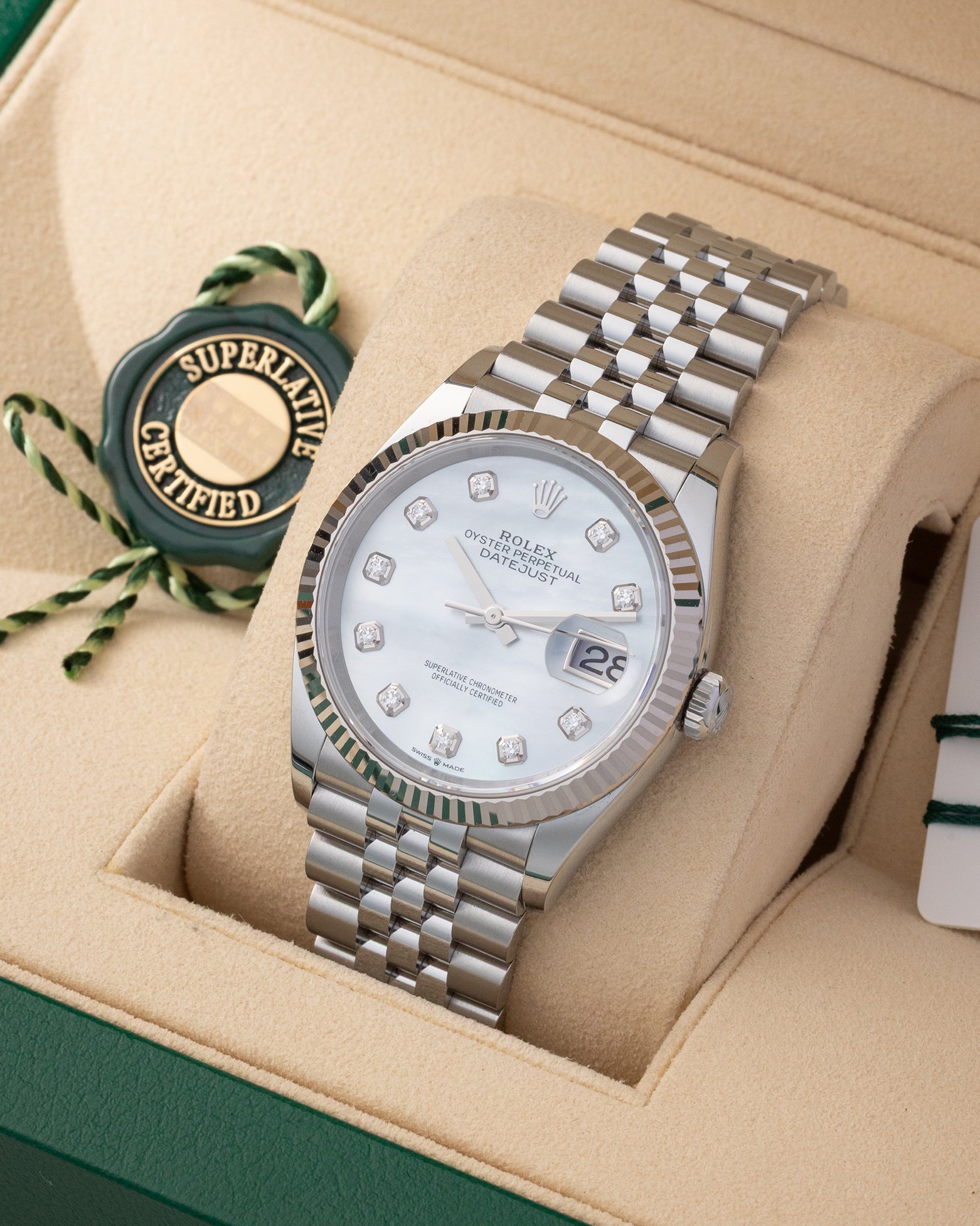 Angled view of Rolex Datejust 36 126234 displaying iridescent white mother of pearl dial, factory diamond hour markers, and fluted bezel