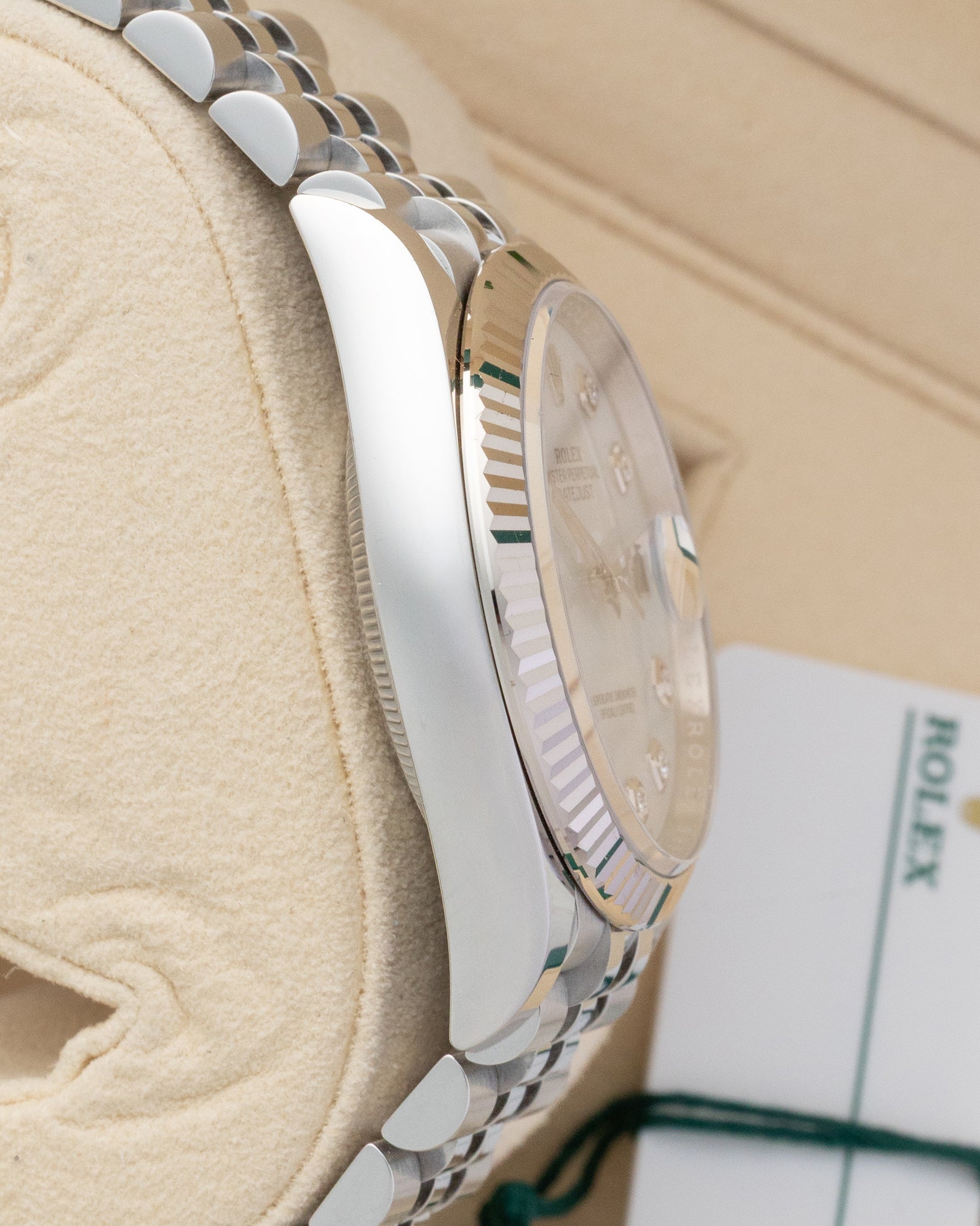 Polished Oystersteel case side profile and 18k white gold fluted bezel view of pre-owned Rolex Datejust 36 reference 126234