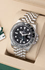 Angled view of Rolex GMT-Master II 126710GRNR showing black dial, green GMT hand, and grey and black ceramic bezel