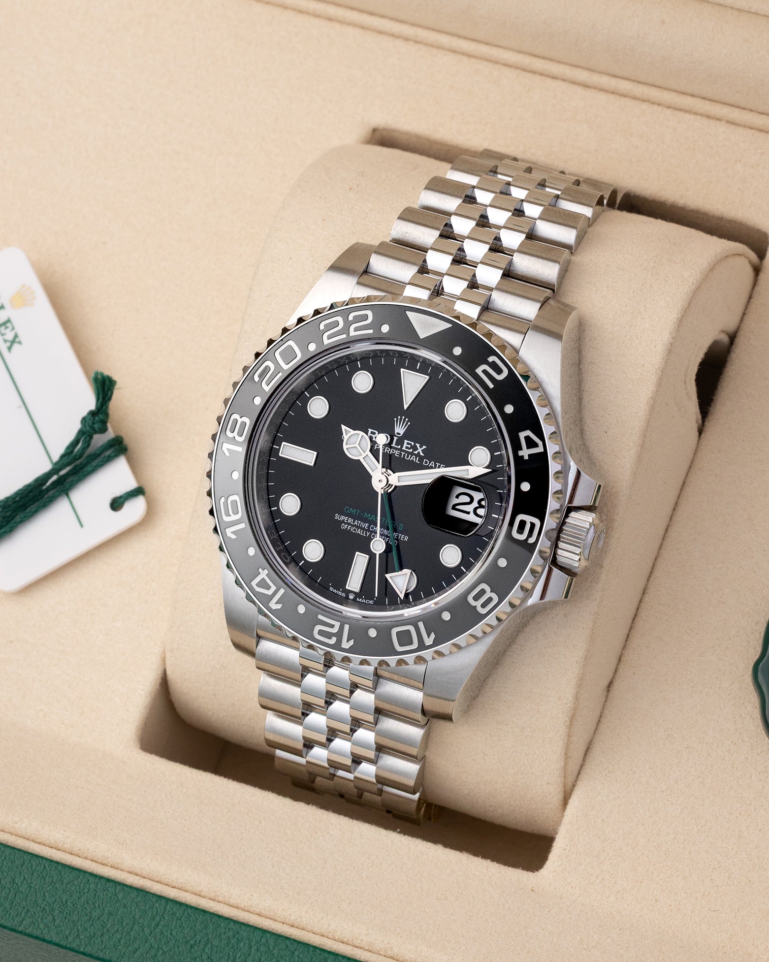 Angled view of Rolex GMT-Master II 126710GRNR showing black dial, green GMT hand, and grey and black ceramic bezel
