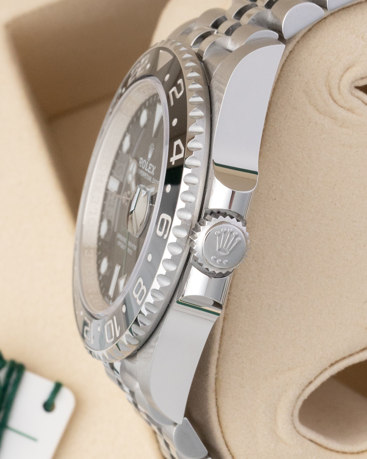 Side profile view of Rolex GMT-Master II 126710GRNR showing Triplock screw-down crown and crown guards