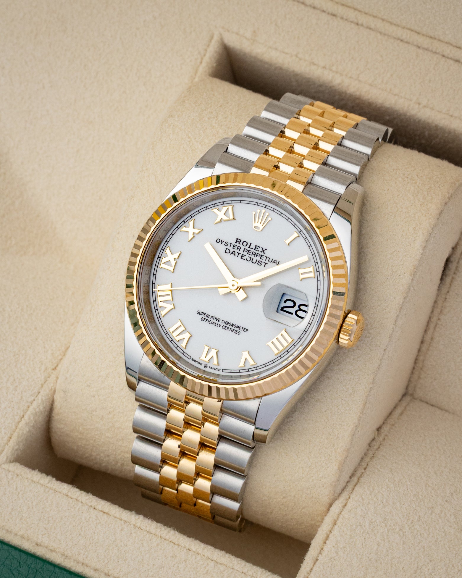 angled photo of a two tone Rolex Datejust 126233 with a white roman dial and jubilee bracelet