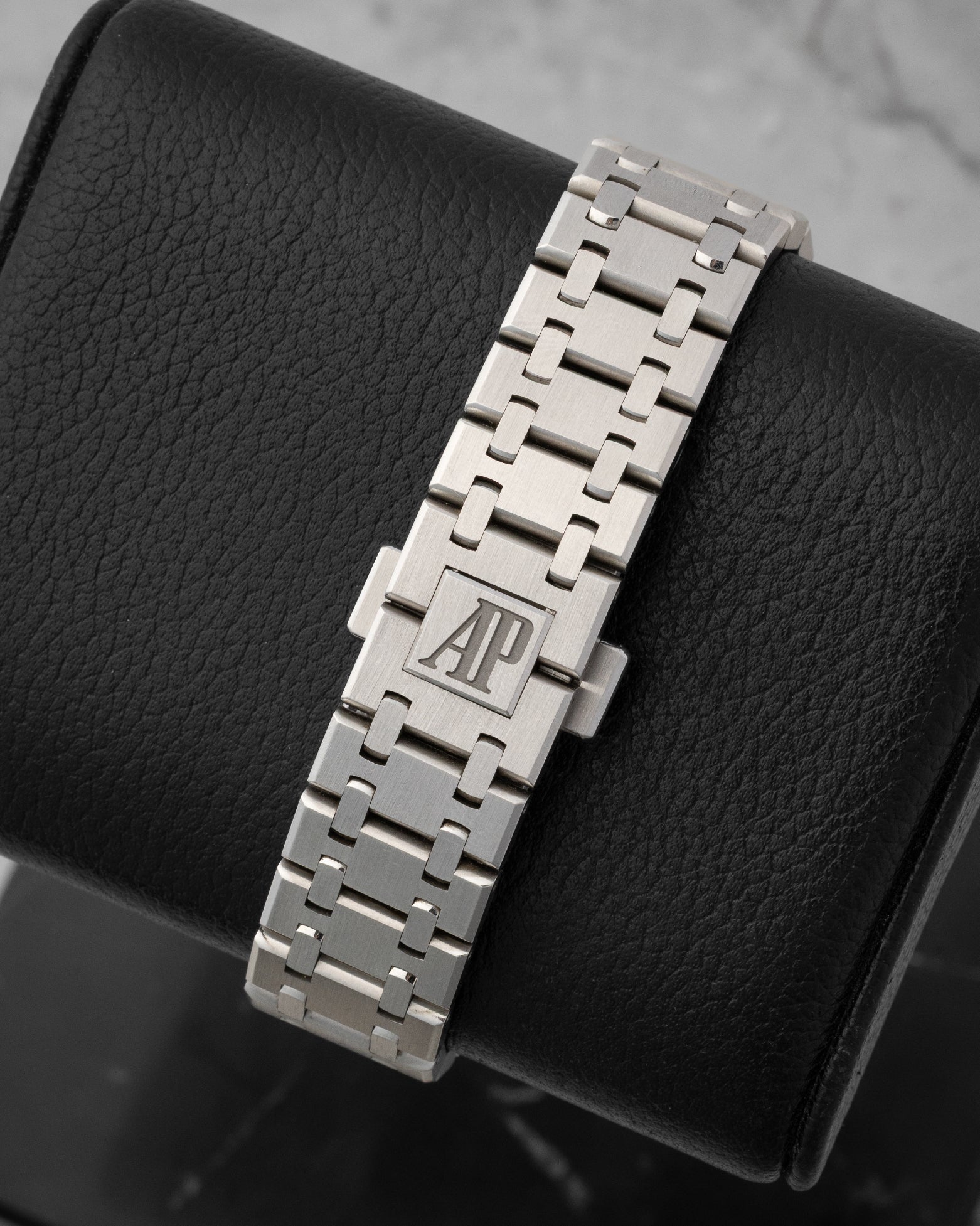 rear snapshot focusing on the brushed stainless steel integrated Royal Oak bracelet and the folding clasp featuring the engraved AP logo