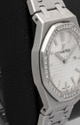 left non-crown profile view of the Audemars Piguet Royal Oak watch showcasing its ultra-thin case profile and satin-brushed integrated bracelet links
