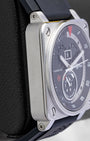 Left-side case profile view of a pre-owned 42mm square steel Bell and Ross B-Rocket watch resting on a black leather presentation block