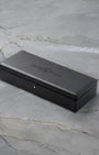 Official sleek black rectangular Bell and Ross presentation watch box debossed with the brand logo sitting on marble