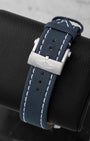 Back view showing the blue leather military strap with stainless steel winged logo tang buckle on a Breitling Avenger GMT A24315101C1X1