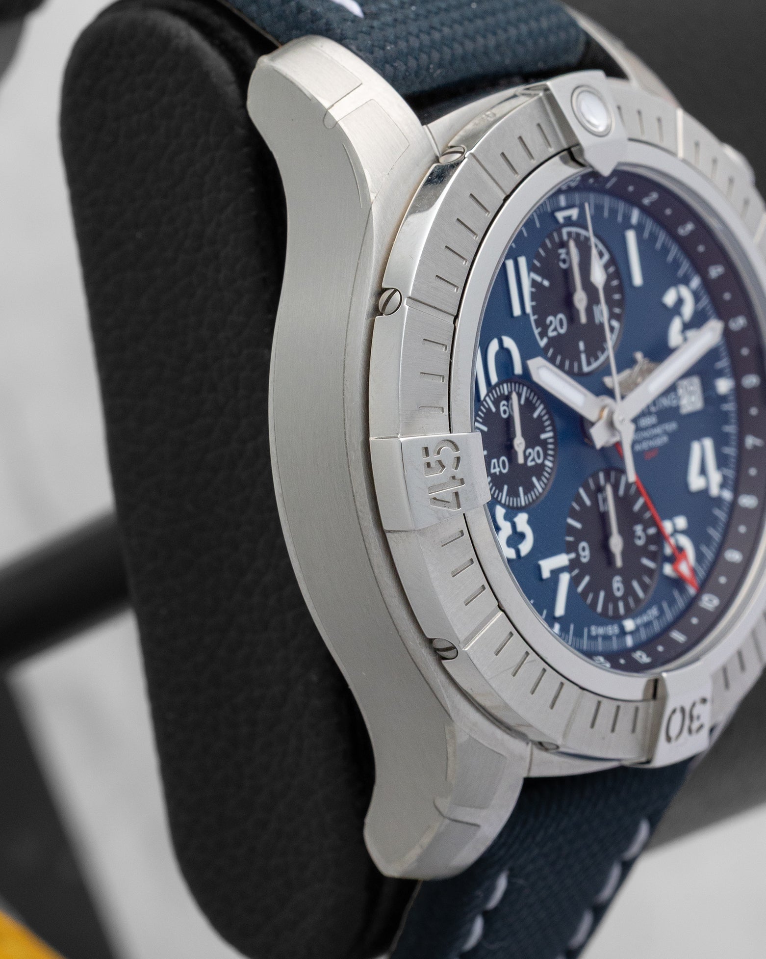 Left side profile view highlighting the satin-brushed stainless steel case and rider tabs on a preowned Breitling Avenger GMT reference A24315101C1X1