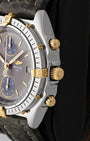 Close-up right-side profile of the two-tone watch head highlighting the classic 18k gold fluted onion-shaped winding crown paired with gold mushroom-style chronograph pushers