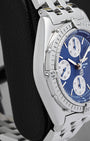 Left side profile showcasing the high-polish stainless steel case edges and curved lugs of the 39mm Breitling Chronomat
