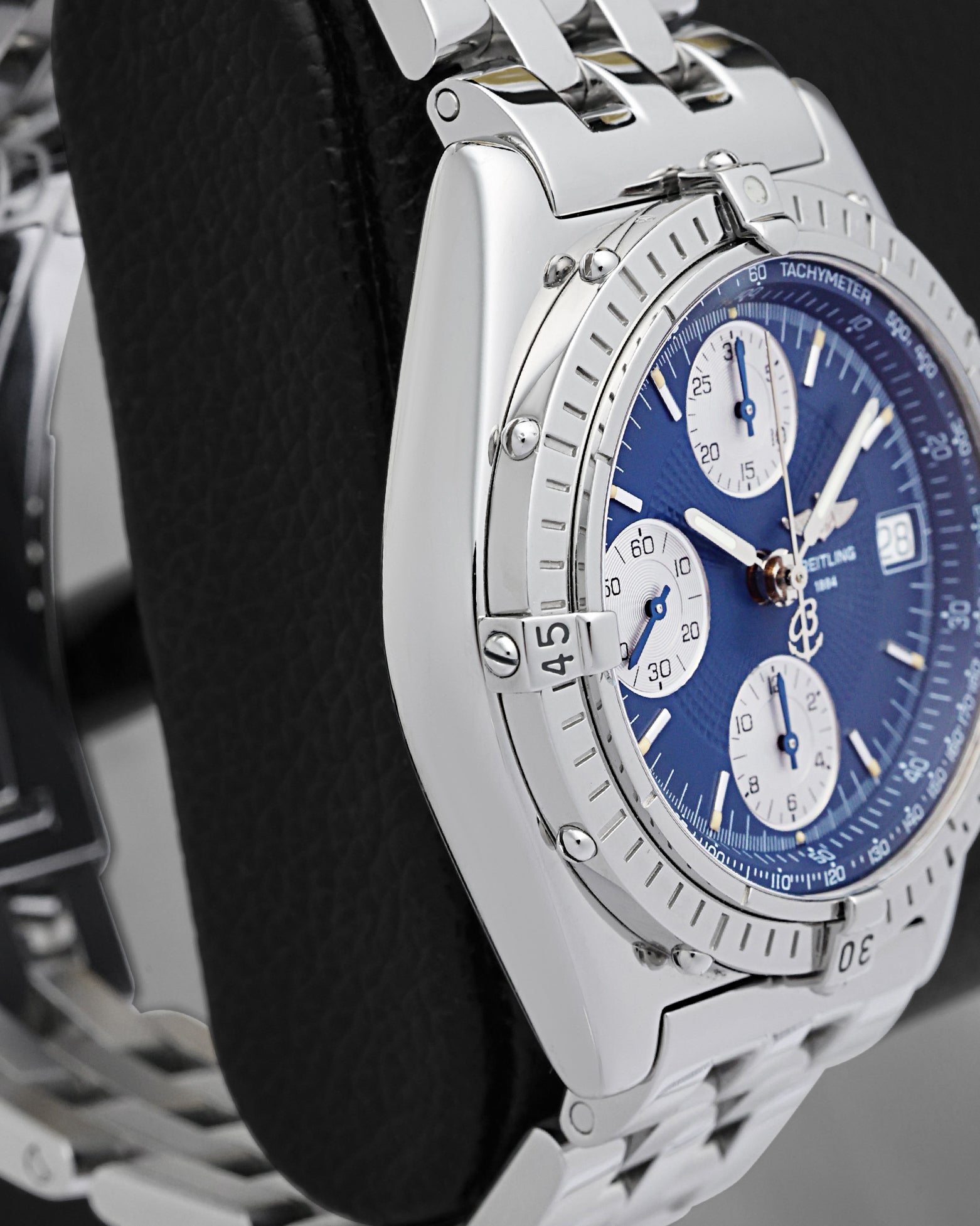 Left side profile showcasing the high-polish stainless steel case edges and curved lugs of the 39mm Breitling Chronomat
