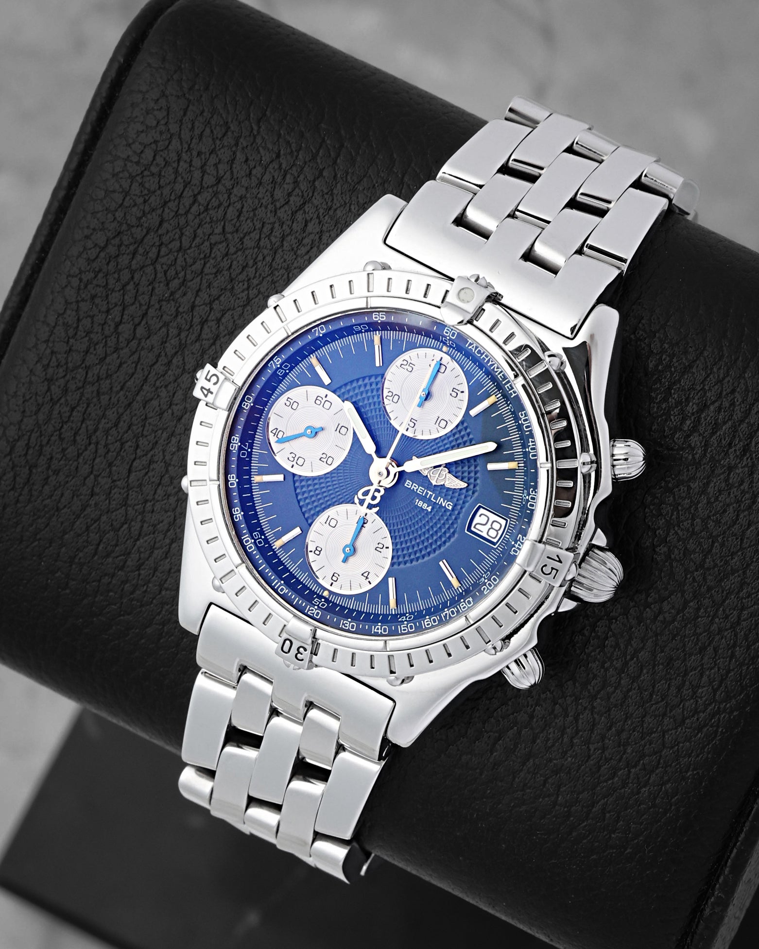 Front angled view of a stainless steel Breitling Chronomat 39mm blue dial luxury pilot watch in Dallas