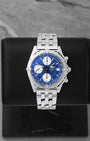 Breitling Chronomat automatic chronograph 39mm watch with a blue dial, silver subdials, model A13050, on display at Noah's Fine Watches & Jewelry in Dallas