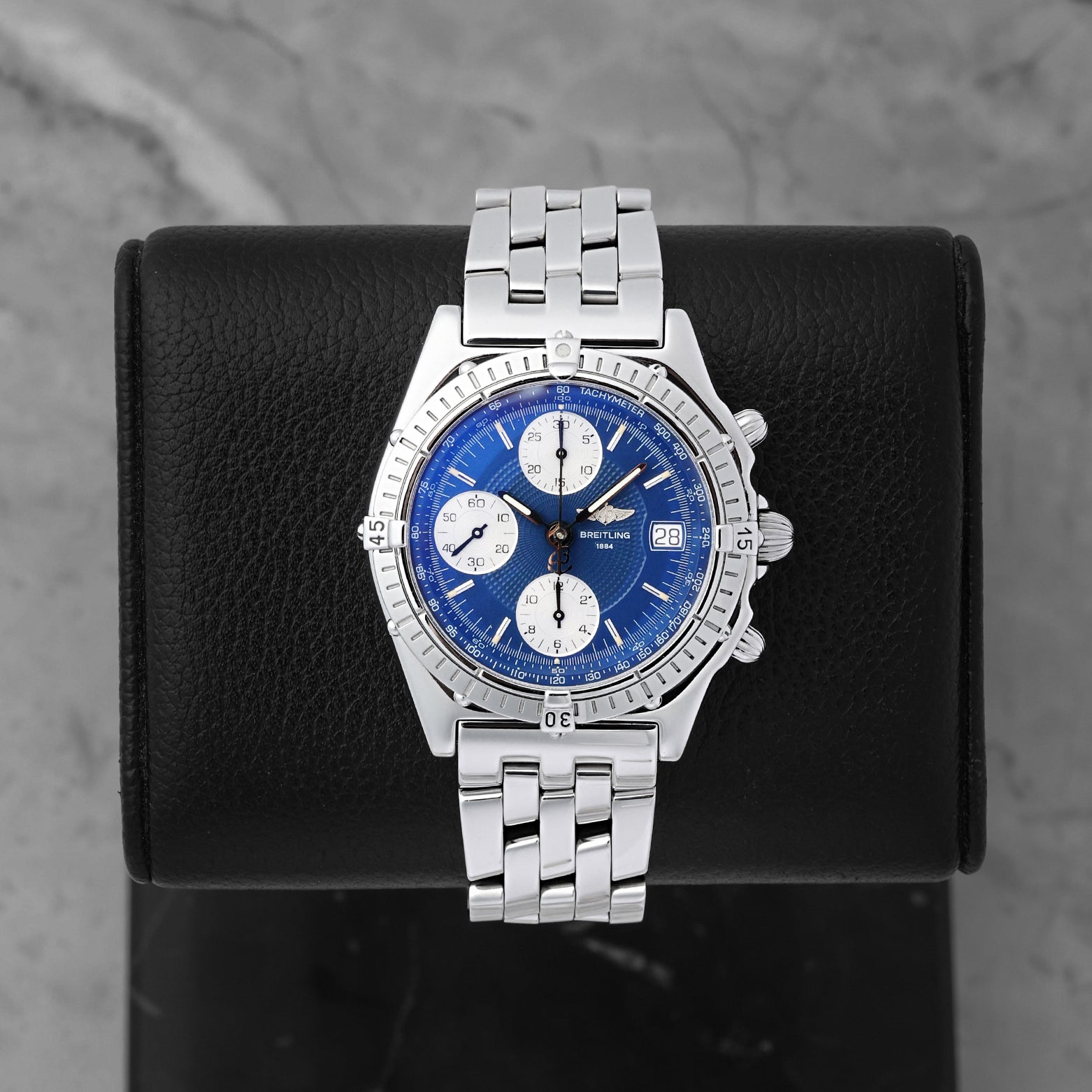 Breitling Chronomat automatic chronograph 39mm watch with a blue dial, silver subdials, model A13050, on display at Noah's Fine Watches & Jewelry in Dallas