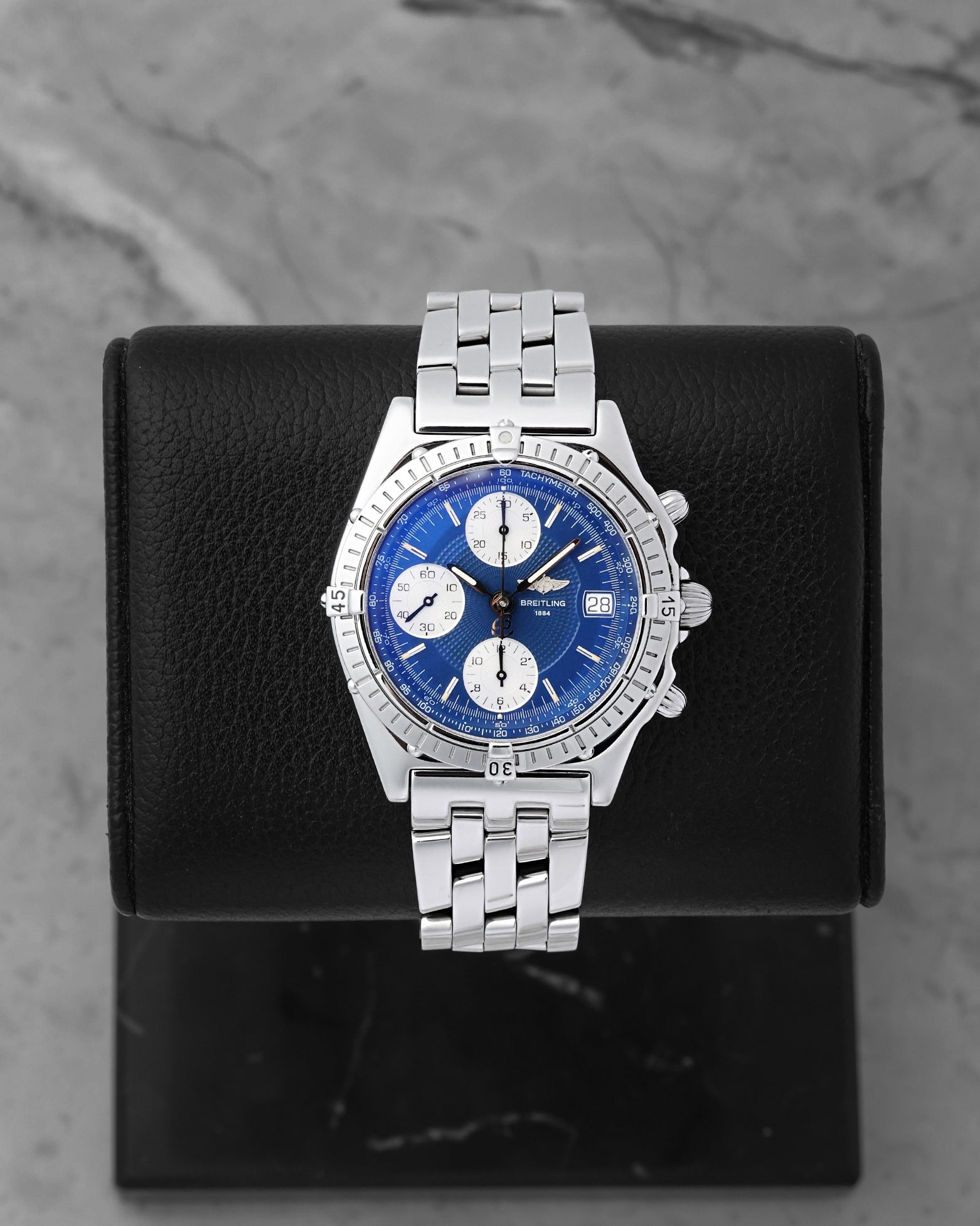 Breitling Chronomat automatic chronograph 39mm watch with a blue dial, silver subdials, model A13050, on display at Noah's Fine Watches & Jewelry in Dallas