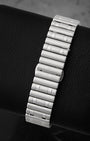 A rear view of the iconic stainless steel Rouleaux bracelet focusing on the uniform cylindrical bullet-shaped links and the clean hidden butterfly deployment clasp interface